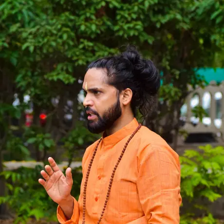 Tarachand ji mid-sentence, explaining a point to a student off camera
